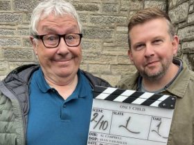 Gregor Fisher and Greg McHugh holding a clapperboard that says Only Child on it