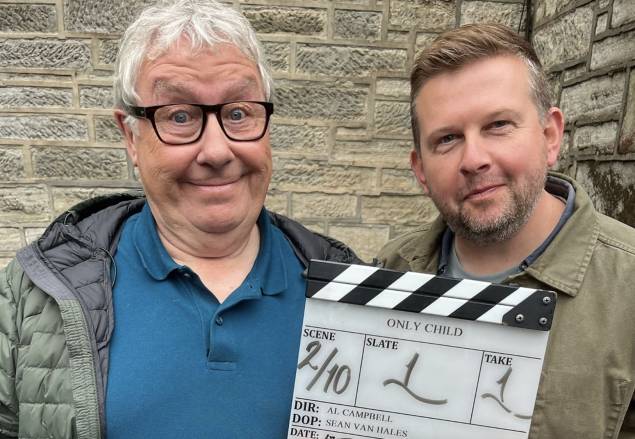 Gregor Fisher and Greg McHugh holding a clapperboard that says Only Child on it