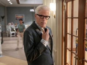 Ted Danson in a office hallway looking into camera and talking into a miniture microphone.