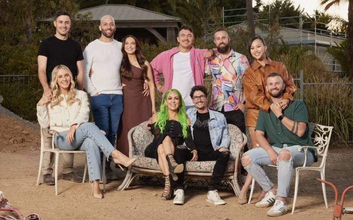 The Block 2024 Cast sitting and standing on a beach type set